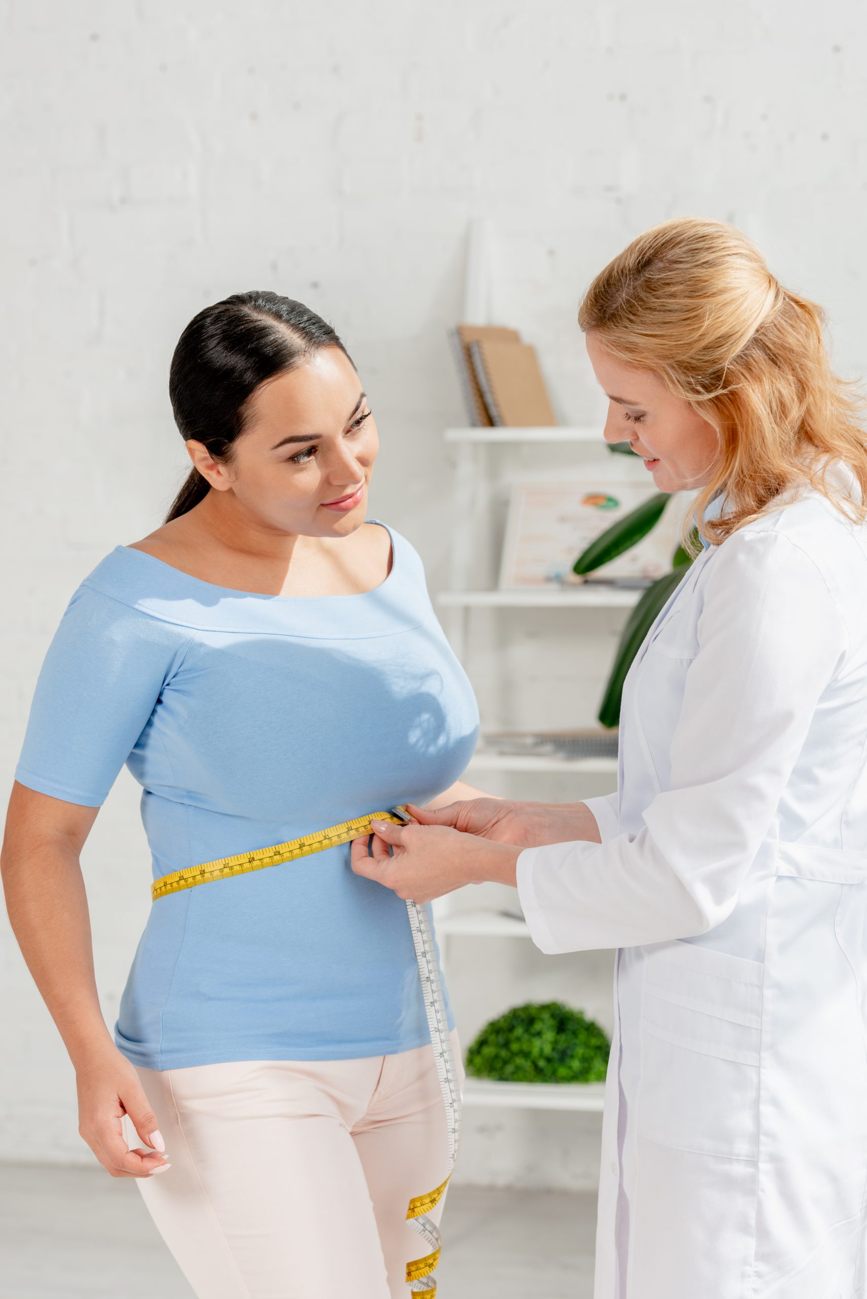 attractive nutritionist measuring body of patient 2022 12 16 20 35 19 utc scaled